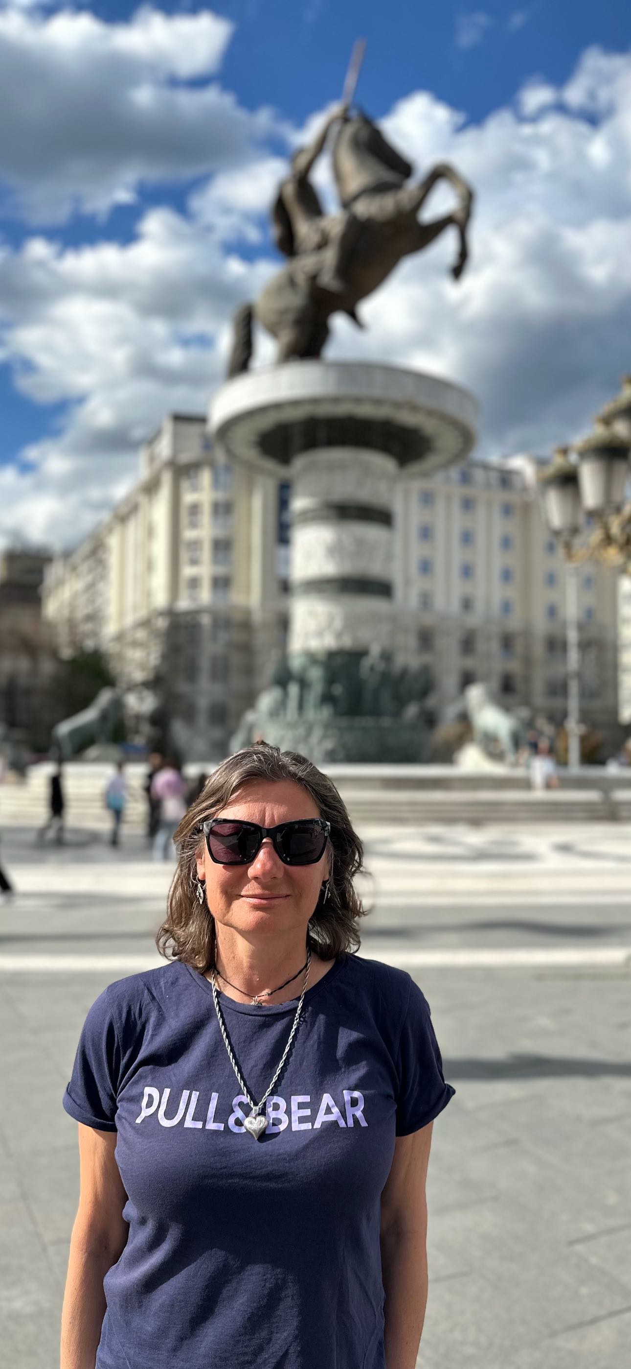 Lena, your local guide in Skopje, standing in front of Alexander the Great statue